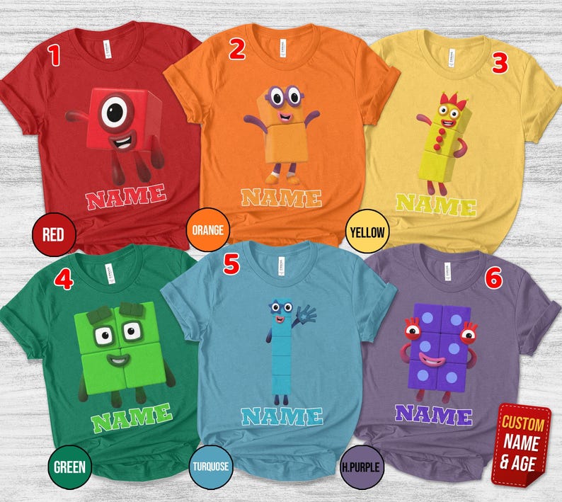 May include: Six short-sleeve t-shirts in red, orange, yellow, green, turquoise, and purple. Each shirt features a Numberblocks character graphic and the word NAME printed below. The shirts are numbered one through six in the top corners.