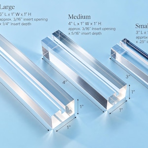May include: Three clear acrylic rectangular sign holders in large, medium, and small sizes. Large: 6" L x 1" W x 1" H, 3/16" opening, 1/4" depth. Medium: 4" L x 1" W x 1" H, 3/16" opening, 5/16" depth. Small: 3" L x 1" W x 0.5" H, 1/8" opening, 0.25" depth.