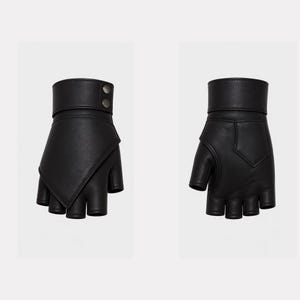 May include: A pair of black fingerless gloves made of leather. The gloves have a wrist strap with two silver-colored buttons. The design features a unique angled flap over the knuckles.