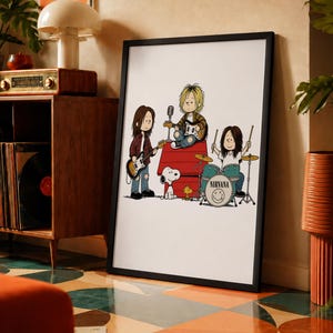 May include: A framed art print featuring a cartoon illustration of the band Nirvana drawn in the style of Peanuts characters. The image shows three band members playing instruments on and around a red doghouse, accompanied by Snoopy and Woodstock.