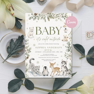 May include: A rectangular baby shower invitation card featuring the text BABY it's cold outside, SOPHIA ANDERSON, and event details. The design includes illustrations of a white fox, leopard cub, penguin, deer fawn, and husky puppy with greenery.