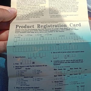 May include: A product registration card for Bausch & Lomb Ray-Ban sunglasses. The card includes sections for personal information, purchase details, and questions about the product and the buyer's preferences.