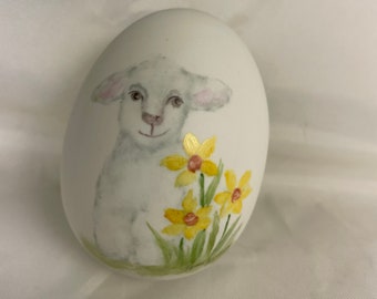 Little white lamb on porcelain egg