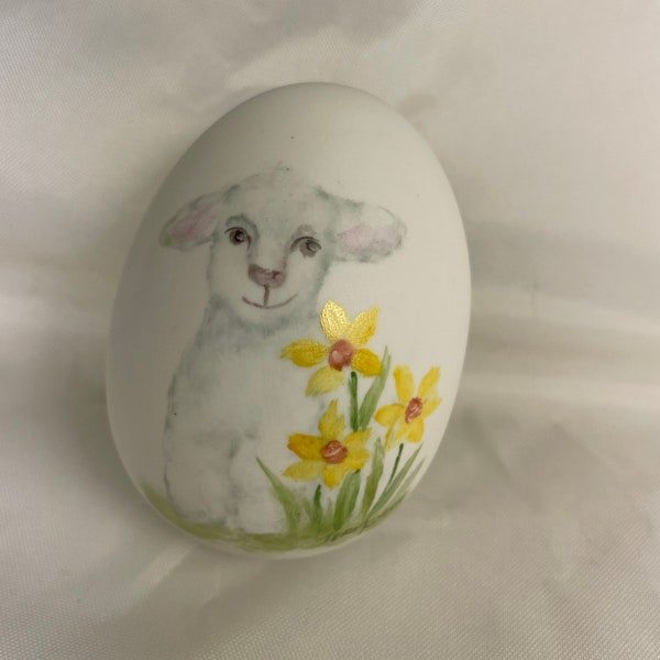 Little white lamb on porcelain egg