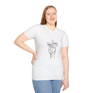 May include: A white short-sleeved t-shirt featuring a black line art graphic on the chest. The design depicts a hand with intricate floral patterns making a middle finger gesture, overlaid with a banner containing the text Vulgar Gesture.