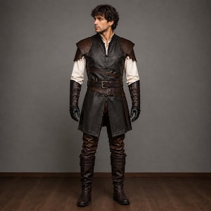May include: A medieval costume with a black leather tunic, brown accents, and shoulder pads. It includes a matching belt, brown leather trousers, boots, and black gloves. A white shirt is visible under the tunic. The outfit is designed for historical reenactment.