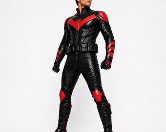 May include: A black and red full-body leather suit featuring a high collar, a red chevron emblem on the chest, matching red shoulder and knee accents, a utility belt with multiple pouches, and black leather boots with red piping and a black mask.