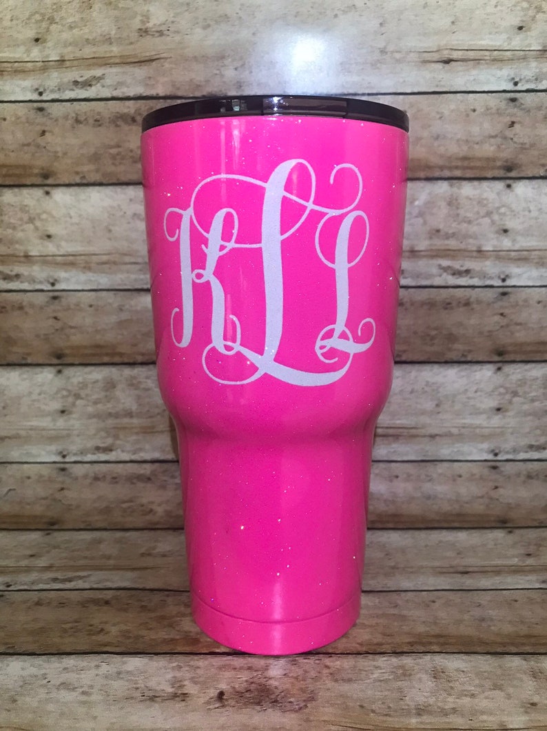 May include: A pink glitter tumbler with a white monogram "KL" on the front.