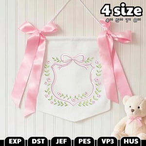 May include: White fabric banner with a pink floral design and a pink ribbon bow at the top. The banner has a shield-shaped design in the center with a bow at the top. The text "4 size" is at the top right, with sizes 4", 5", 7", and 8".