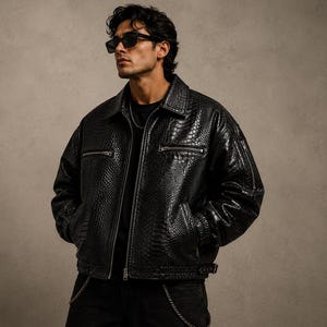 Men’s oversized black python embossed leather jacket with glossy reptile texture, luxury streetwear fashion jacket with premium designer aesthetic.