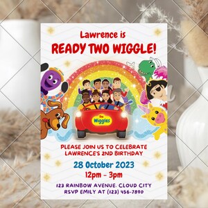 May include: A rectangular birthday invitation card featuring The Wiggles characters in a red car under a rainbow. Text reads: Lawrence is READY TWO WIGGLE! PLEASE JOIN US TO CELEBRATE LAWRENCE'S 2ND BIRTHDAY 28 October 2023 12pm - 3pm 123 RAINBOW AVENUE. CLOUD CITY RSVP EMILY AT (123) 456-7890.