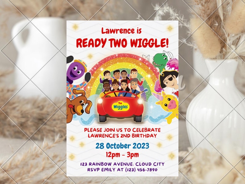 May include: A rectangular birthday invitation card featuring The Wiggles characters in a red car under a rainbow. Text reads: Lawrence is READY TWO WIGGLE! PLEASE JOIN US TO CELEBRATE LAWRENCE'S 2ND BIRTHDAY 28 October 2023 12pm - 3pm 123 RAINBOW AVENUE. CLOUD CITY RSVP EMILY AT (123) 456-7890.