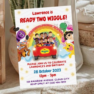 May include: A rectangular birthday invitation card featuring The Wiggles characters, a red car, and a rainbow. Text reads: Lawrence is READY TWO WIGGLE! PLEASE JOIN US TO CELEBRATE LAWRENCE'S 2ND BIRTHDAY 28 October 2023 12pm - 3pm 123 RAINBOW AVENUE. CLOUD CITY RSVP EMILY AT (123) 456-7890.