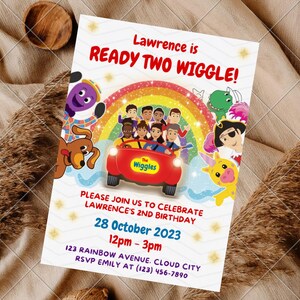 May include: A rectangular birthday invitation card featuring The Wiggles characters, a red car, and a rainbow. The text reads: Lawrence is READY TWO WIGGLE! PLEASE JOIN US TO CELEBRATE LAWRENCE'S 2ND BIRTHDAY 28 October 2023 12pm - 3pm 123 RAINBOW AVENUE. CLOUD CITY RSVP EMILY AT (123) 456-7890.