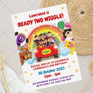May include: A rectangular birthday invitation card featuring The Wiggles characters, a red car, and a rainbow. The text reads: Lawrence is READY TWO WIGGLE! PLEASE JOIN US TO CELEBRATE LAWRENCE'S 2ND BIRTHDAY 28 October 2023 12pm - 3pm 123 RAINBOW AVENUE. CLOUD CITY RSVP EMILY AT (123) 456-7890.