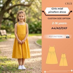 May include: A young girl wearing a yellow midi pinafore dress stands on a path. The dress has a square neckline and a gathered skirt. The image includes text that says "Girls midi pinafore dress" and "2-16 years".