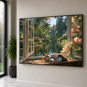 May include: A rectangular wall art print featuring an open window overlooking a calm river surrounded by lush green trees. A tabby cat rests on the wooden windowsill next to a glass vase filled with pink flowers, bathed in warm sunlight.