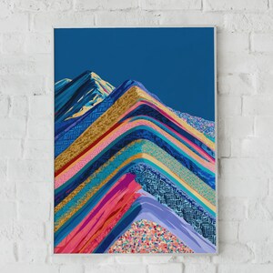 May include: A rectangular wall art print featuring a stylized mountain range composed of layered, diagonal bands of vibrant colors including deep blue, gold, magenta, and teal. The design incorporates intricate geometric patterns and textures.