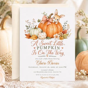 May include: A white baby shower invitation card featuring a watercolor illustration of a bunny sitting on a large orange pumpkin, surrounded by smaller pumpkins, autumn leaves, and flowers. The text reads A Sweet Little PUMPKIN Is On The Way.