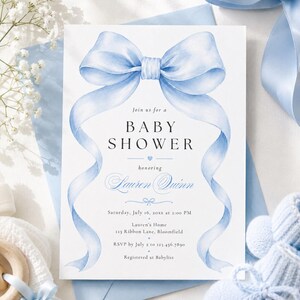 May include: A white rectangular baby shower invitation card featuring a large watercolor light blue ribbon bow at the top with long flowing tails. The text reads: Join us for a BABY SHOWER honoring Lauren Quinn, Saturday, July 16, 20xx at 2:00 PM.