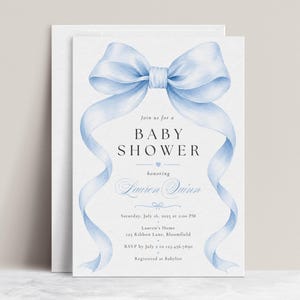 May include: A white baby shower invitation card featuring a large, light blue watercolor bow at the top with long, flowing ribbons framing the text. The card includes the text: Join us for a BABY SHOWER honoring Lauren Quinn, Saturday, July 16, 2025 at 2:00 PM, Lauren's Home, 123 Ribbon Lane, Bloomfield, RSVP by July 2 to 123.456.7890, Registered at Babylist.
