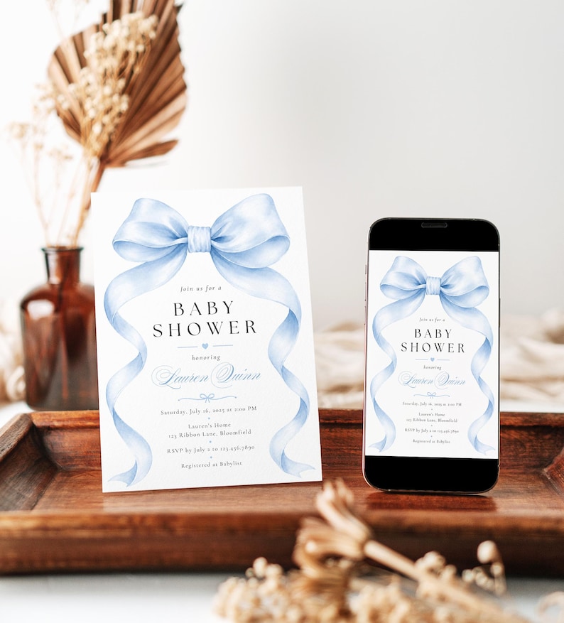 May include: A white baby shower invitation card and a smartphone displaying the same invitation design. Both feature a large, light blue watercolor bow at the top with flowing ribbons and black text that reads: Join us for a BABY SHOWER honoring Lauren Quinn, Saturday, July 16, 2025 at 2:00 PM, Lauren's Home, 123 Ribbon Lane, Bloomfield, RSVP by July 2 to 123.456.7890, Registered at Babylist.