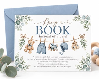 May include: A rectangular card with a blue envelope featuring the text Bring a BOOK instead of a card. The design includes watercolor illustrations of a teddy bear, overalls, a toy airplane, a bonnet, and booties hanging on a clothesline.