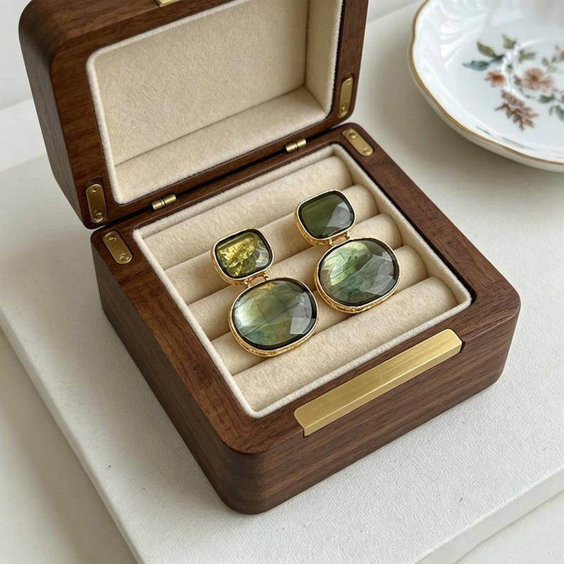 Handmade green gemstone drop earrings with Gold-Tone finish, beautifully presented inside a dark wood jewelry box.