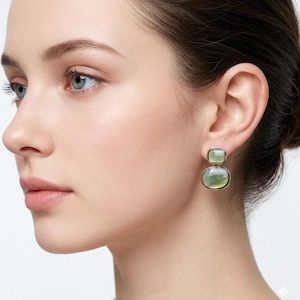 Model wearing a mid-century retro style olive green shell drop earring, showcasing its elegant proportion and sophisticated everyday statement look, perfect for French vintage and minimalist style styling.