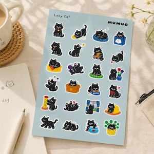 May include: A light blue sticker sheet titled Lazy Cat by MUMUO featuring twenty-four individual die-cut illustrations of black cats in various poses, including playing with yarn, sitting in boxes, eating, and interacting with household objects.