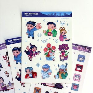 May include: A sticker sheet titled Ace Attorney featuring various chibi-style characters from the game series. The sheet includes illustrations of characters in blue suits, eating ramen, sitting with flowers, and wearing futuristic visors.