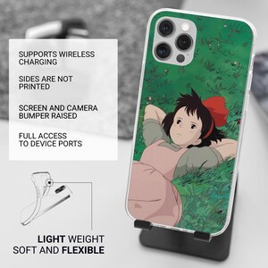 May include: A clear phone case featuring a cartoon illustration of a girl with a red bow lying in grass. The case has a green background and a raised bumper for the screen and camera. The text on the left says "SUPPORTS WIRELESS CHARGING" and "LIGHT WEIGHT SOFT AND FLEXIBLE."