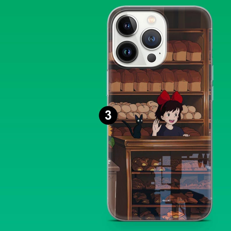 May include: Clear phone case featuring a bakery scene with a young girl with a red bow, a black cat, and shelves of bread. The case has a green background and a number 3.