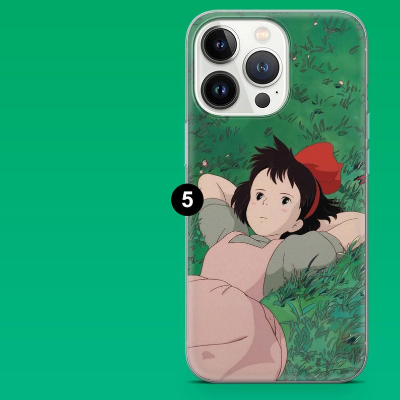 May include: Clear phone case featuring a cartoon illustration of a girl with a red bow in her hair, lying in a field of green grass. The case has a green background with a white border and a black number 5.