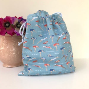 Wild swimmers gift, cold water swim toiletries bag with waterproof lining, gift for swimmer, blue or red drawstring wash bag.