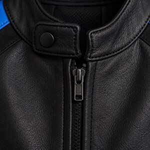 May include: A black leather jacket featuring a mandarin collar with a snap button closure and a central metal zipper. The shoulders are accented with vibrant blue leather panels that contrast against the primary black leather construction.
