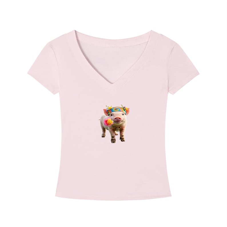 May include: A light pink V-neck t-shirt featuring a graphic of a pig wearing a floral headband and holding a flower in its mouth. The pig is centered on the shirt. The shirt is made of a soft material.