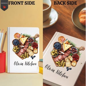 May include: Notebook with a charcuterie board illustration, including olives, cheese, salami, and crackers. The text "Olivia Kitchen" is written in a script font. The notebook is shown from the front and back, with a cup of coffee and croissant.