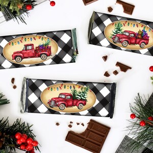 May include: Three red and white candy bar wrappers with a black and white buffalo plaid pattern. Each wrapper features a red vintage truck with a Christmas tree and lights.