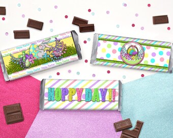 May include: Three Easter-themed chocolate bar wrappers. One wrapper features a bunny rabbit with eggs and flowers, another has a basket of eggs with flowers, and the third has the text "Hoppy Day!" in colorful letters.