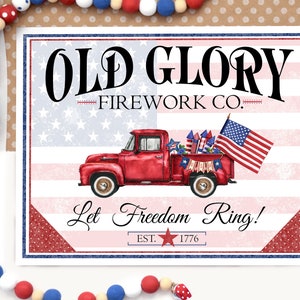 May include: A red, white, and blue patriotic sign with a red pickup truck carrying fireworks and an American flag. The sign reads "Old Glory Firework Co. Let Freedom Ring! Est. 1776".