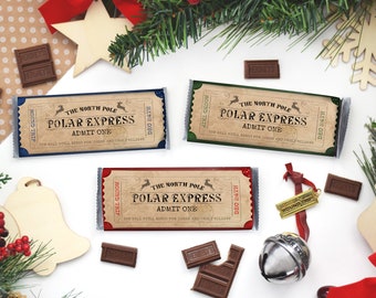 May include: Three chocolate bars wrapped in paper with a Polar Express ticket design. The tickets are red, blue, and green. The tickets have the text "The North Pole Polar Express Admit One" and "Round Trip Dec 24th".