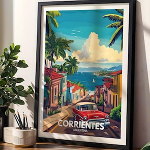 May include: A framed travel poster featuring a red vintage car on a street in Corrientes, Argentina, with palm trees, colorful buildings, and a blue sea under a cloudy sky. The text CORRIENTES ARGENTINA is printed in white at the bottom.