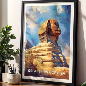 May include: A framed wall art print featuring a stylised illustration of the Great Sphinx of Giza in Egypt. The artwork displays warm golden tones for the monument against a vibrant blue and white sky. The text reads GREAT SPHINX OF GIZA EGYPT.