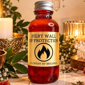 May include: A small amber glass bottle with a silver screw cap and a gold label featuring the text FIERY WALL OF PROTECTION and a flame icon. The label also includes the brand name Alchemy by Breanna in black lettering on the front.