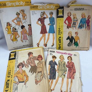 May include: A collection of vintage sewing patterns from Simplicity and McCall's. The patterns feature illustrations of various clothing designs, including dresses, blouses, and tops. The covers are in various colors, with text indicating sizes and prices.