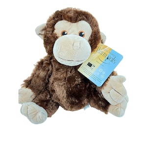 May include: A plush monkey toy with dark brown fur and a light beige face, ears, hands, and feet. The monkey has orange eyes and a tag attached to its arm that reads Marvin Monkey Warm pals, featuring icons of a microwave and snowflakes.