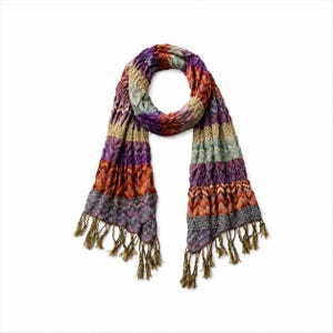 May include: A long, textured scarf featuring a multi-colored chevron pattern in shades of purple, orange, blue, and tan. The fabric has a crinkled appearance with horizontal bands of varying knit textures and long, thin fringe at both ends.
