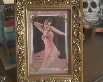Vintage lingerie ad mixed media framed collage.