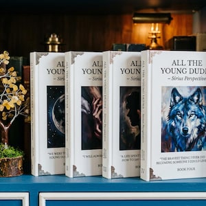 May include: Four books titled "ALL THE YOUNG DUDES - Sirius Perspective" are displayed on a blue shelf. The book covers feature illustrations of a wolf, a silhouette, and other abstract images. A decorative tree and swan are also visible.